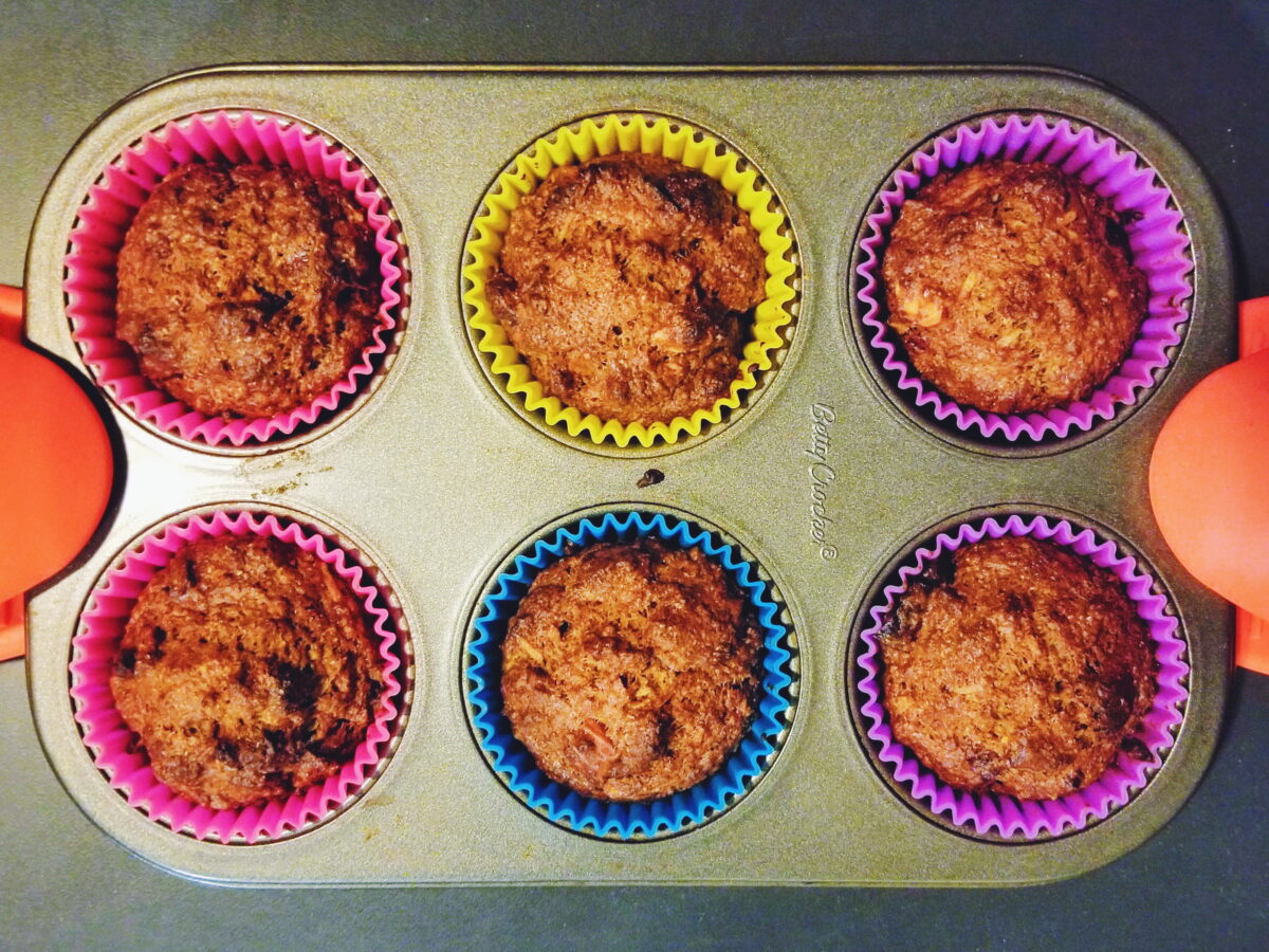 healthier morning glory muffins in silicon molds in a muffin tin.