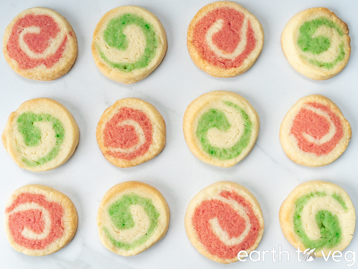 Baked icebox Christmas cookies on a parchment paper-lined baking sheet.