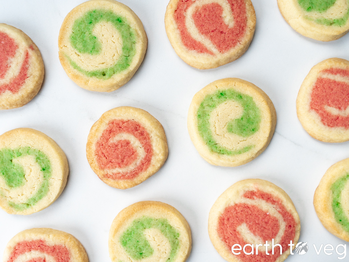 Baked vegan pillsbury cookies on a parchment paper baking sheet.