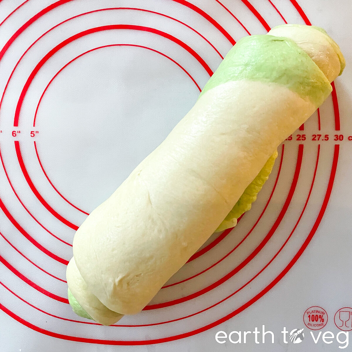 Pandan bread dough rolled up into a log.