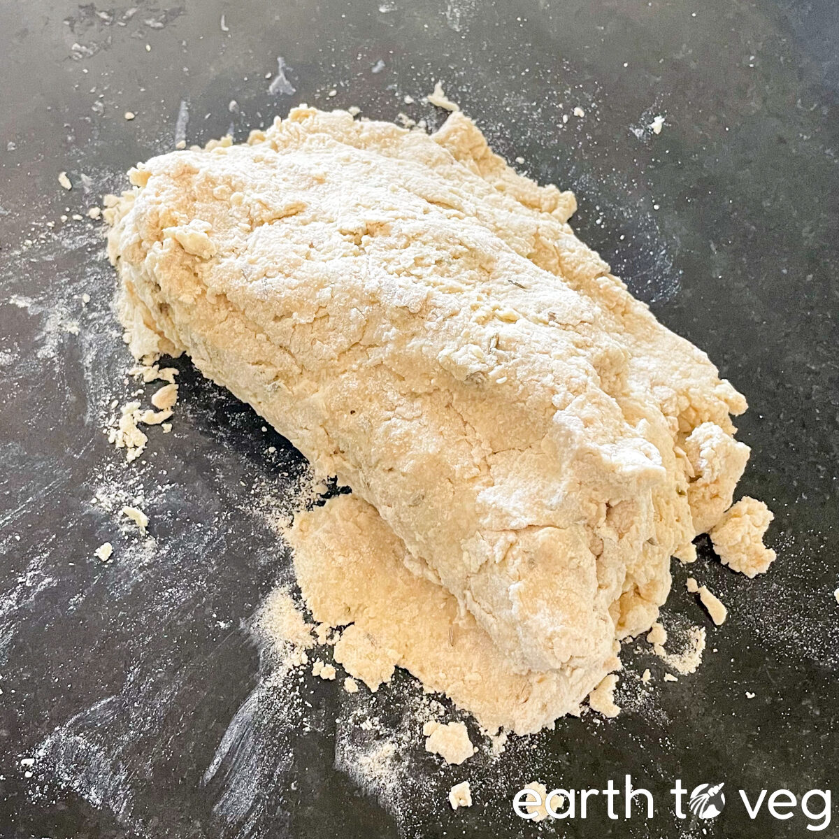 The soda bread dough is patted into a rough rectangular shape.