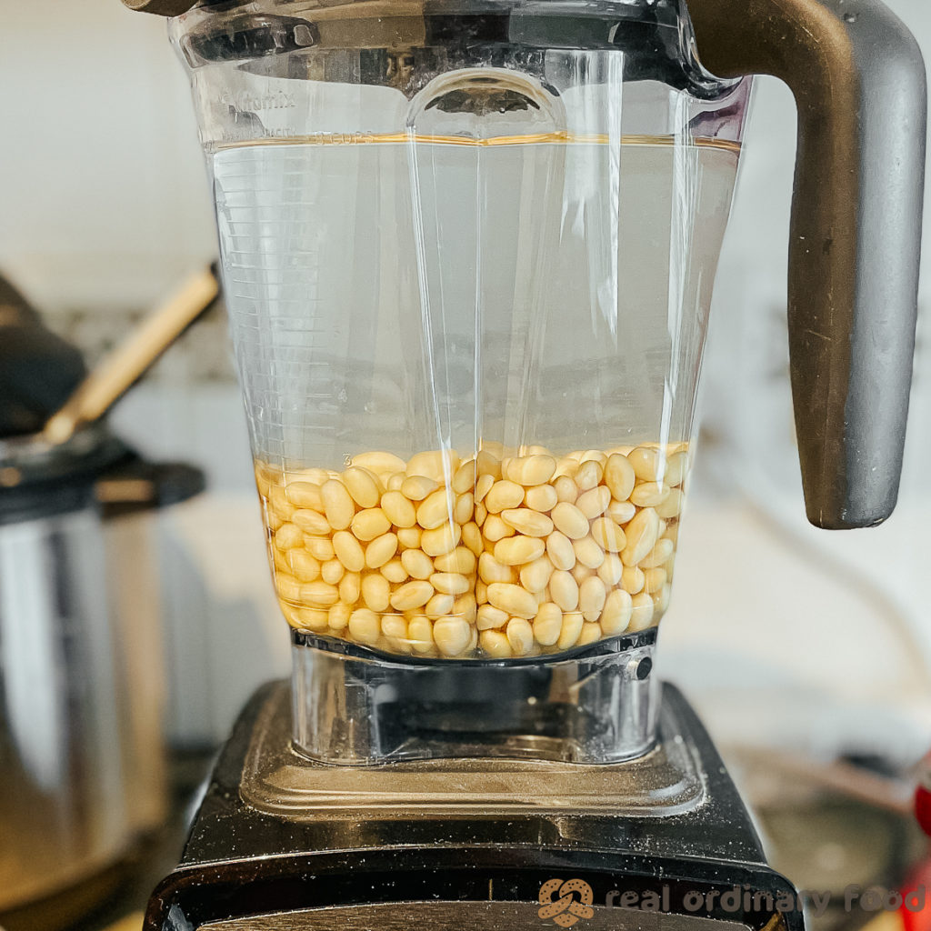 soybeans and cold water sitting in a blender.