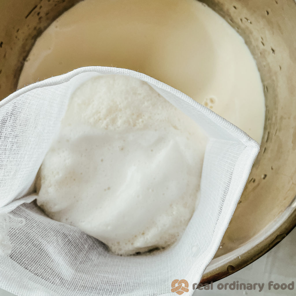 straining soy milk through a nut bag or soup bag into an instant pot.