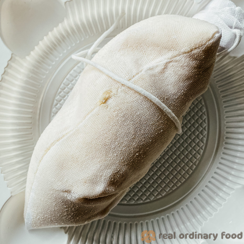 strained okara (soy pulp) left in the nut milk bag.