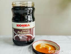 An open jar of Turkish grape molasses on the kitchen counter.