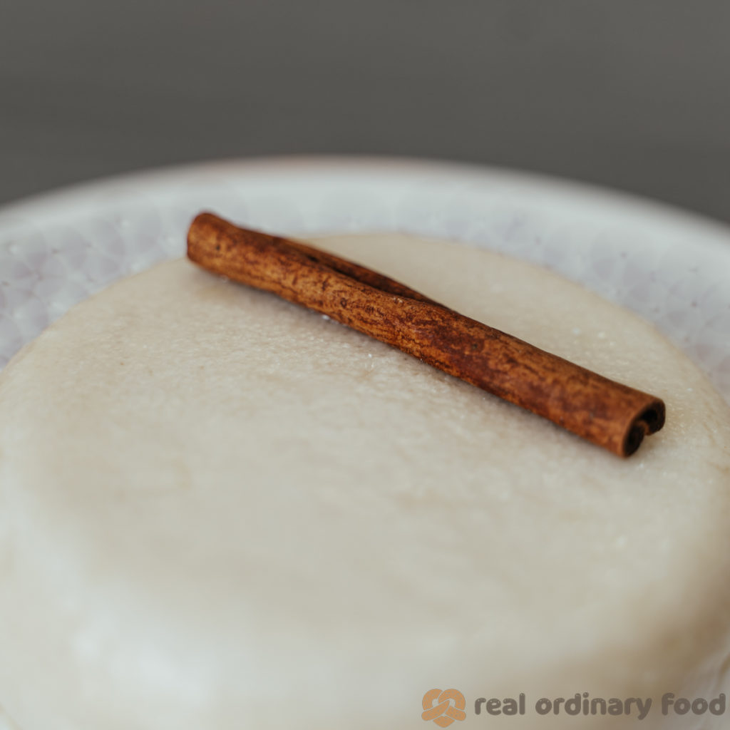 A closeup of my attempt at a 10th-century mahalabia recipe, topped with a cinnamon stick.