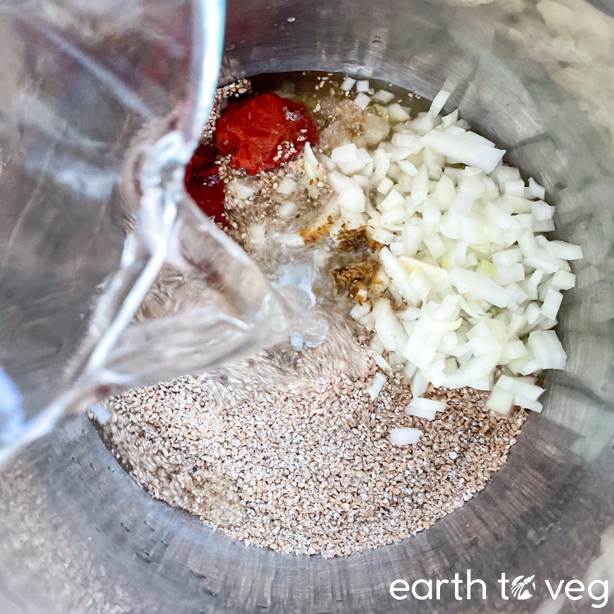 Water being poured into an Instant Pot filled with kisir base ingredients.