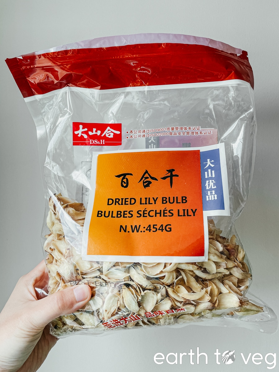 hand holding package of dried lily bulbs