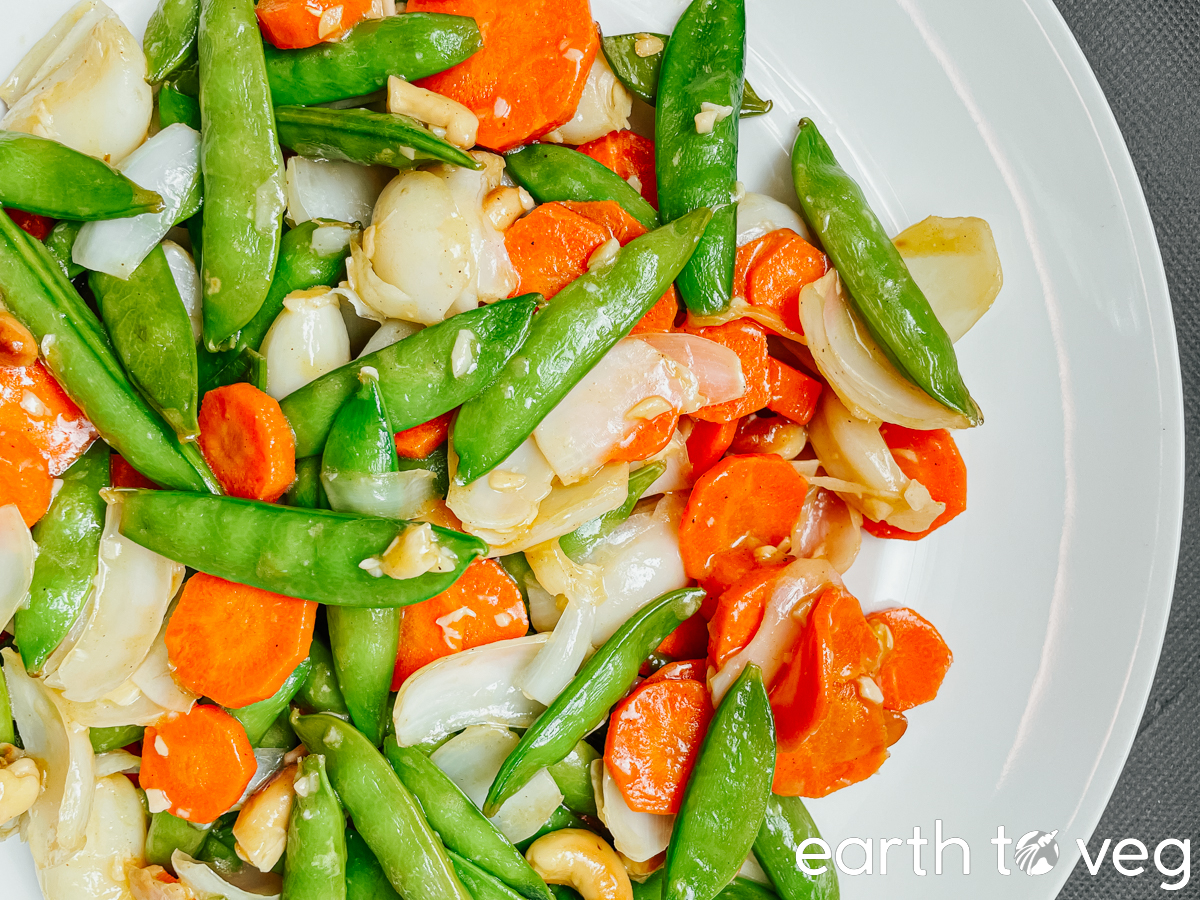 A plateful of lily bulb stir fry topped with celery leaves.