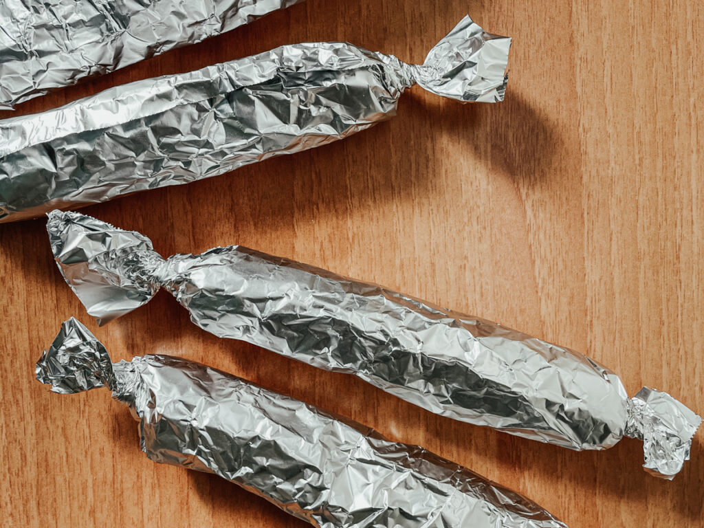 vegan sausages wrapped in tin foil