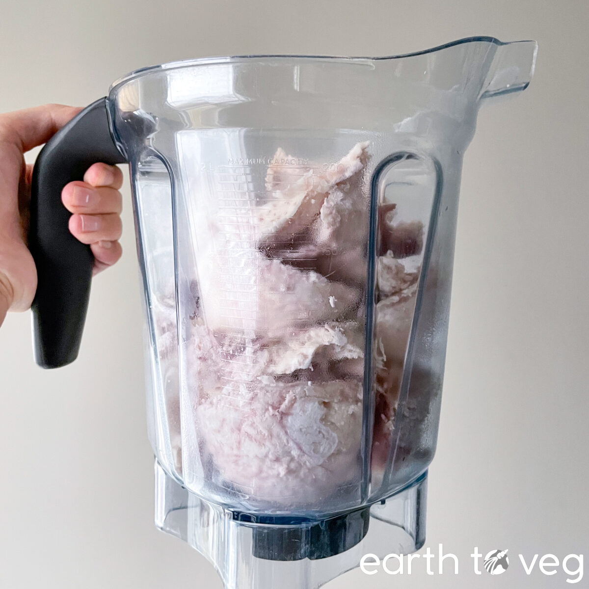 Cooked taro pieces are added to a Vitamix blender.