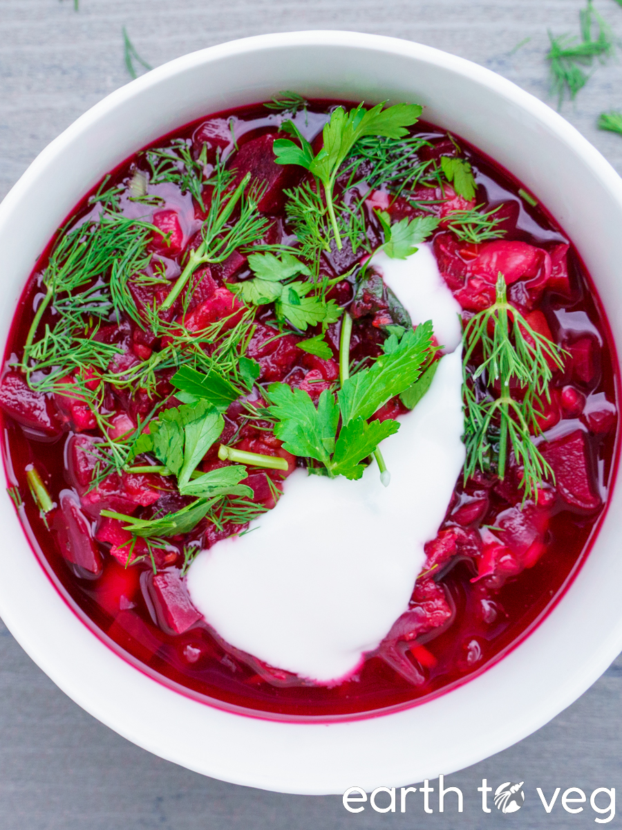 vegan ukrainian borscht with dill, parsley, and dairy free sour cream