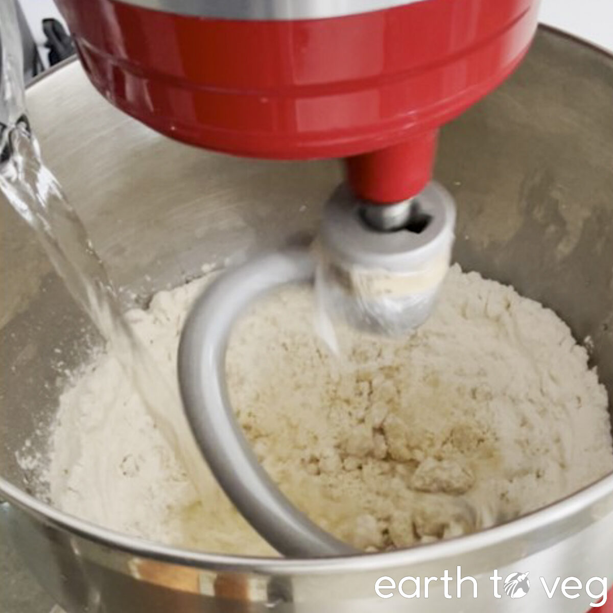 Boiling water is poured into a spinning stand mixer.