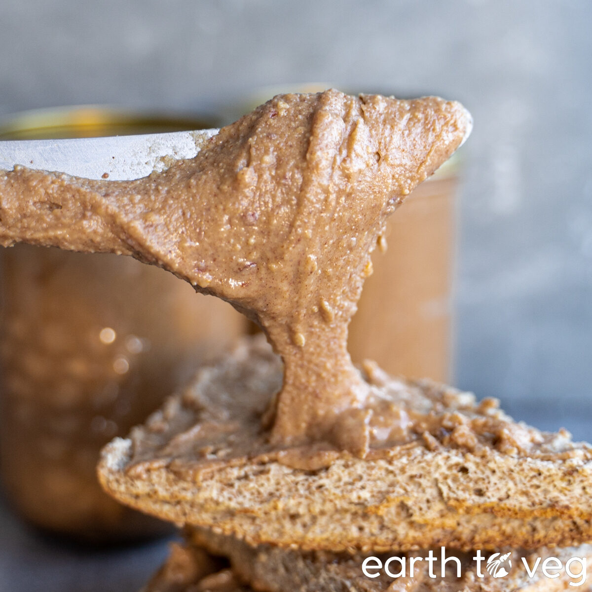 knife lifting up a generous dollop of homemade peanut butter