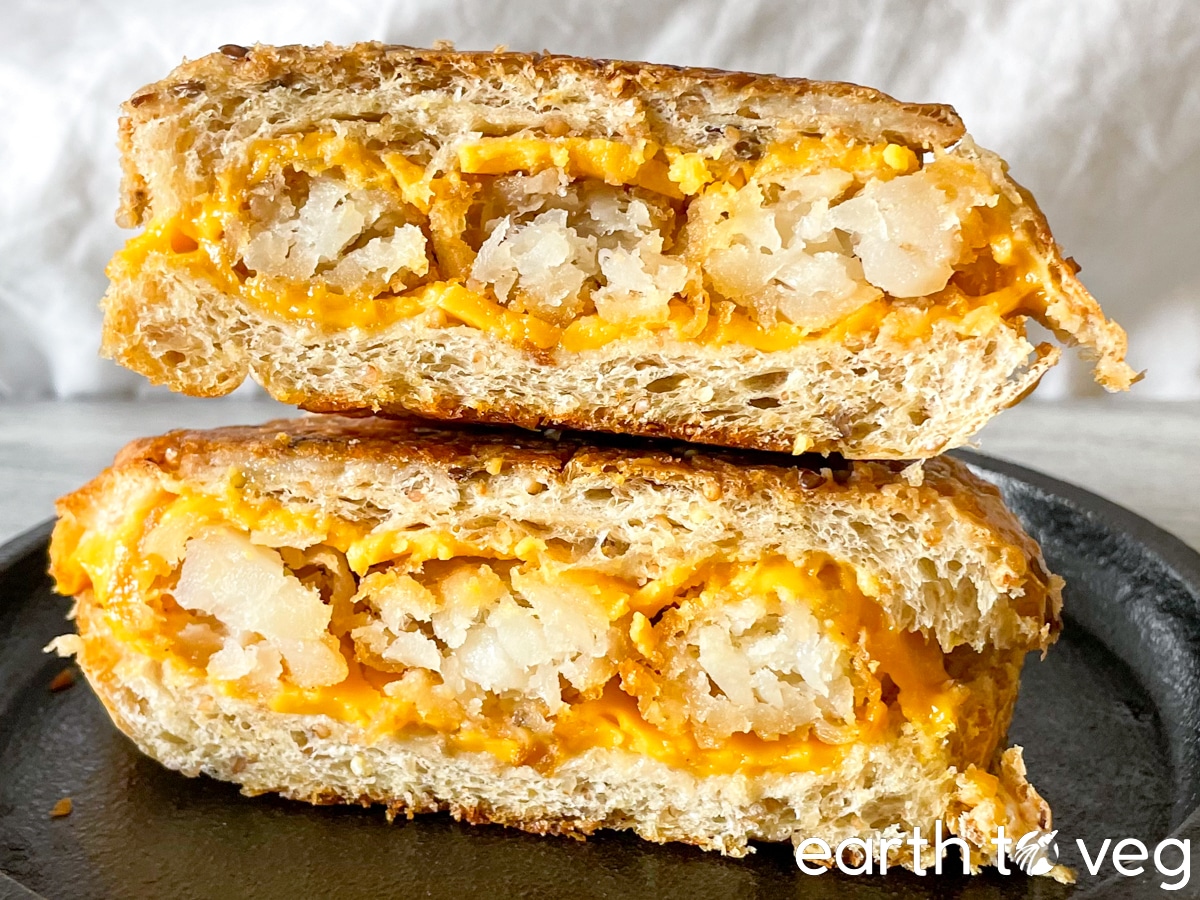 tater tot melt sliced in half on a cast iron skillet