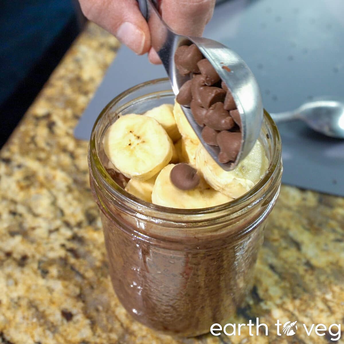 topping chia pudding with banana slices and chocolate chips