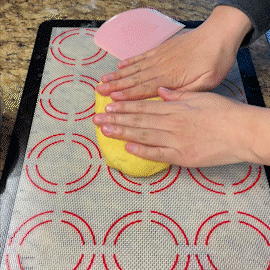 i demonstrate how to shape paska dough into a giant roll shape.