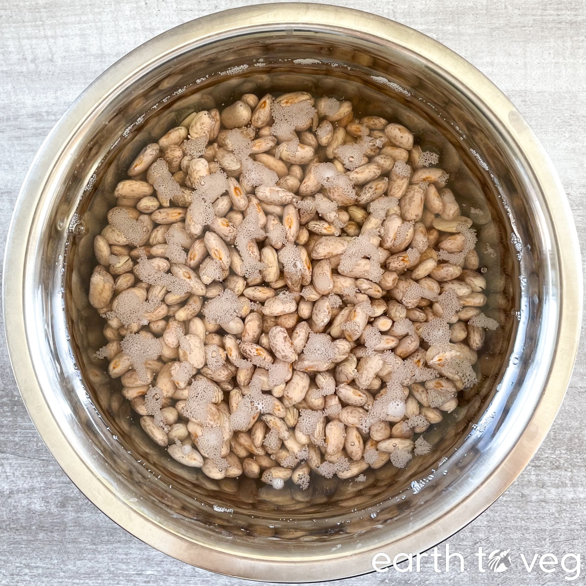 The pinto beans have been soaking for 16 hours in this stainless steel bowl.