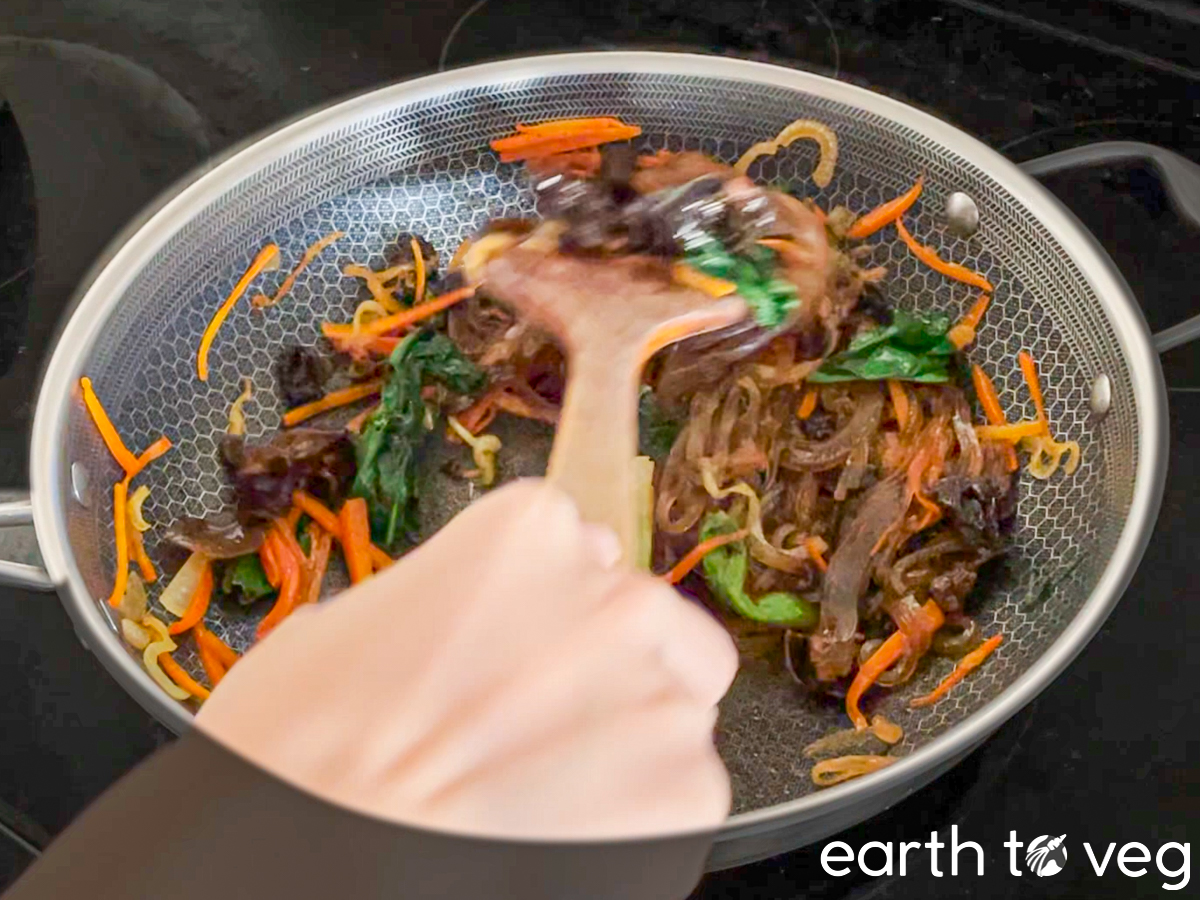 I use a wooden spatula to mix together all the japchae ingredients.