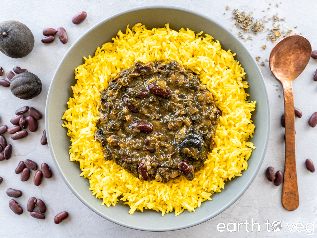 Vegetarian ghormeh sabzi over saffron rice in a large gray bowl next to a copper spoon.