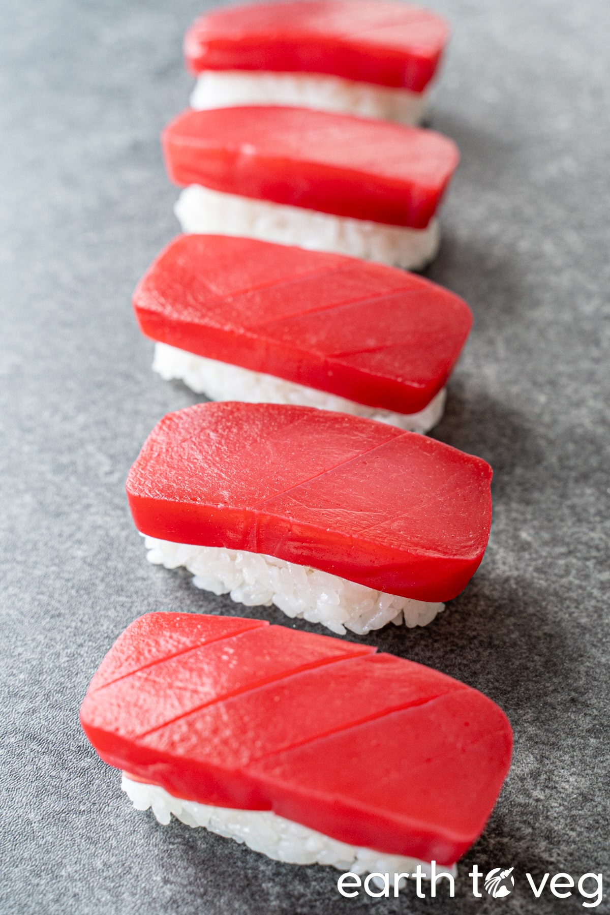 Konjac sashimi pieces on beds of white sushi rice.