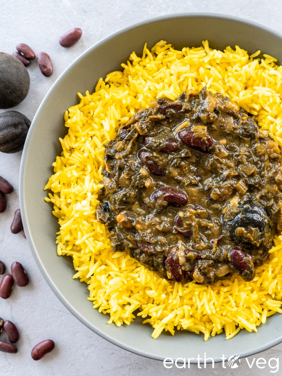 Vegan qormeh sabzi over yellow rice in a grey bowl.