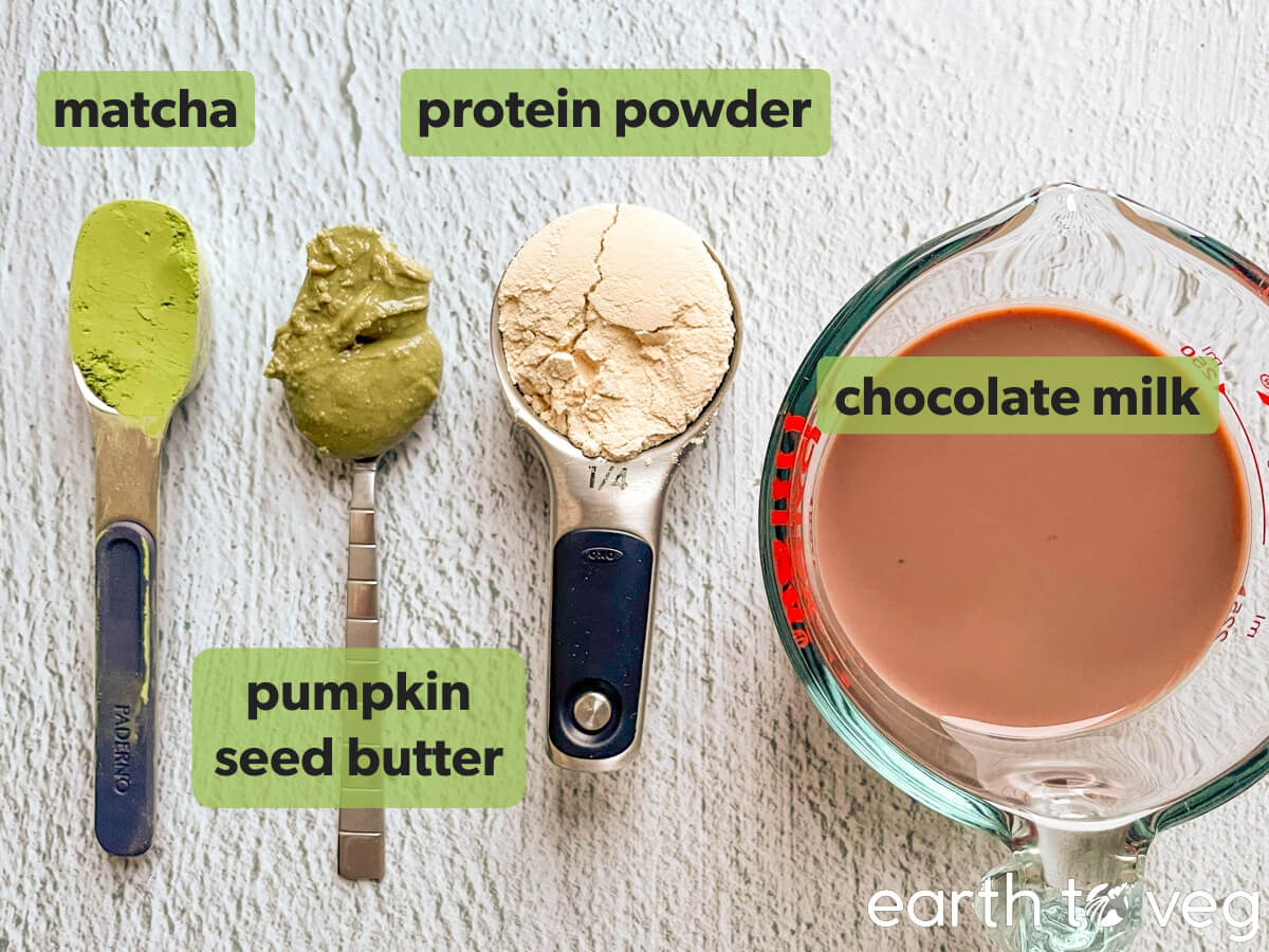 Ingredients for chocolate matcha protein smoothie on a grey counter.