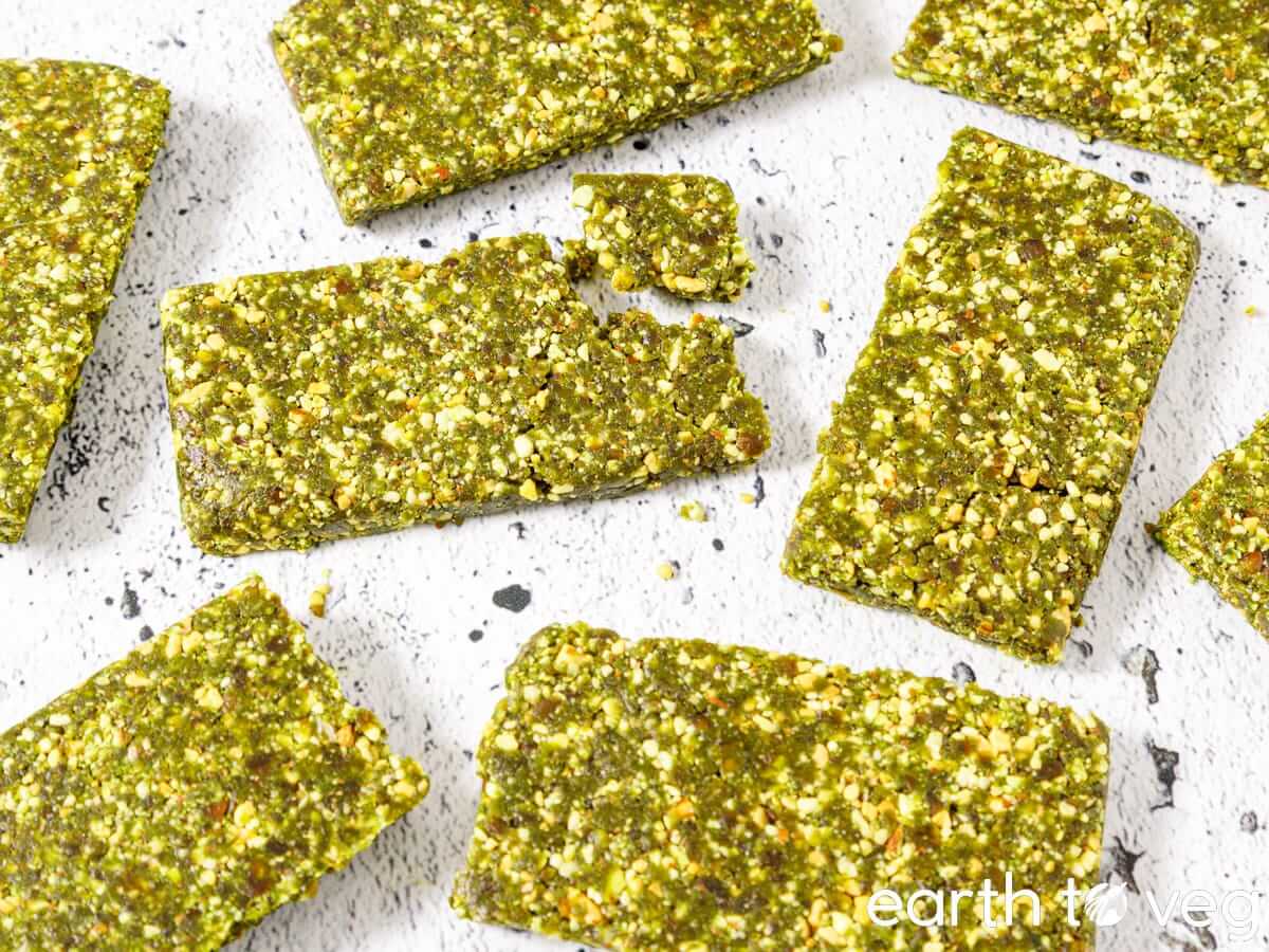 Homemade matcha lara bars on a white tabletop.