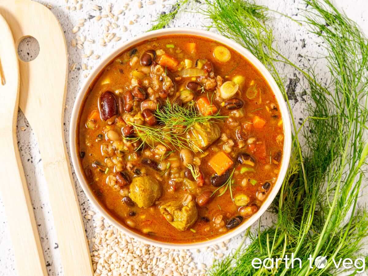 A bowl of Afghan Mashawa with barley and mixed beans.